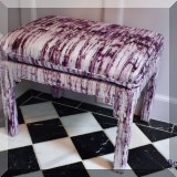 F15. Plush bench upholstered in a plum hand striped fabric. 22”h x 28”w x 21”d 